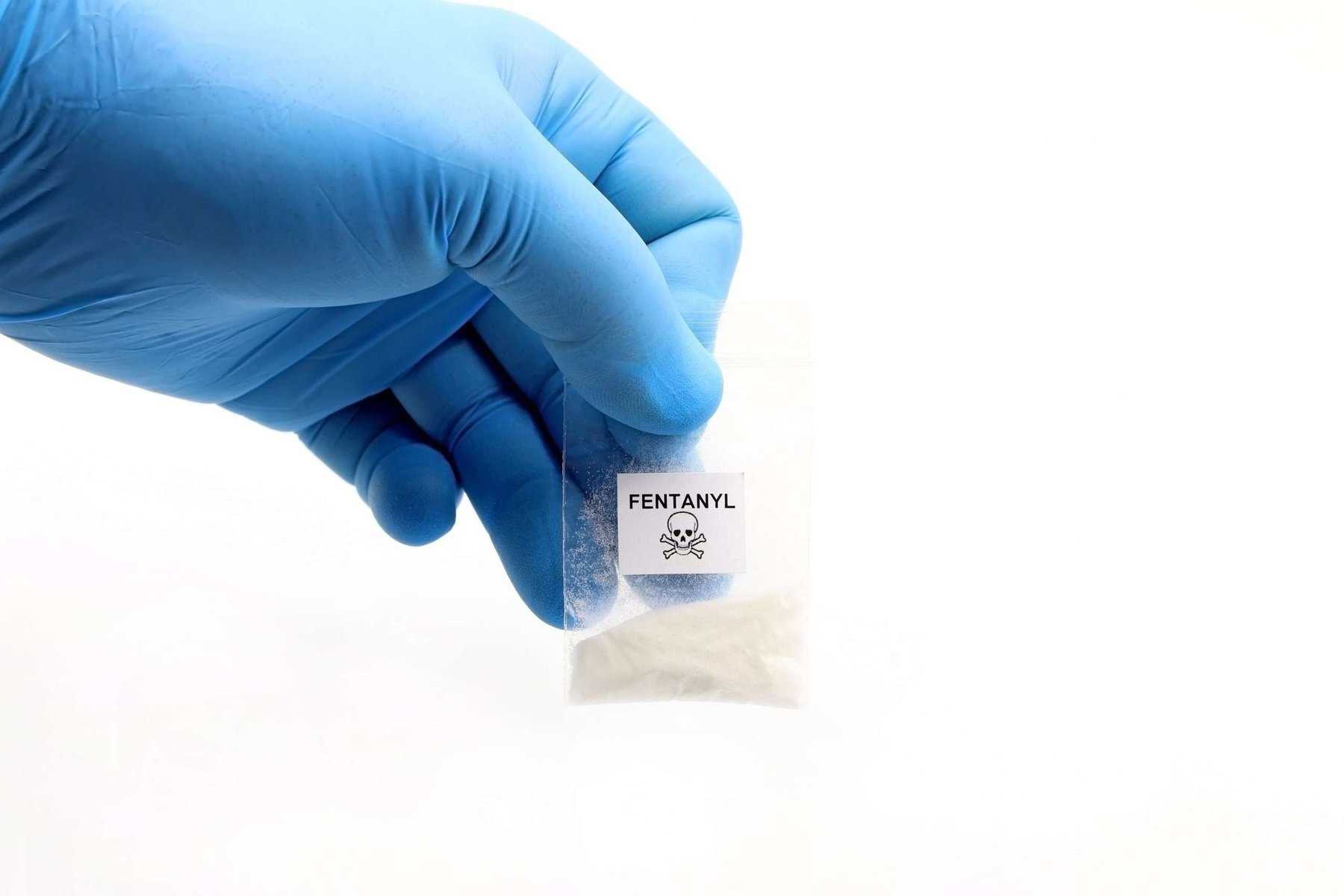gloved hand holding baggie with dangerous fentanyl