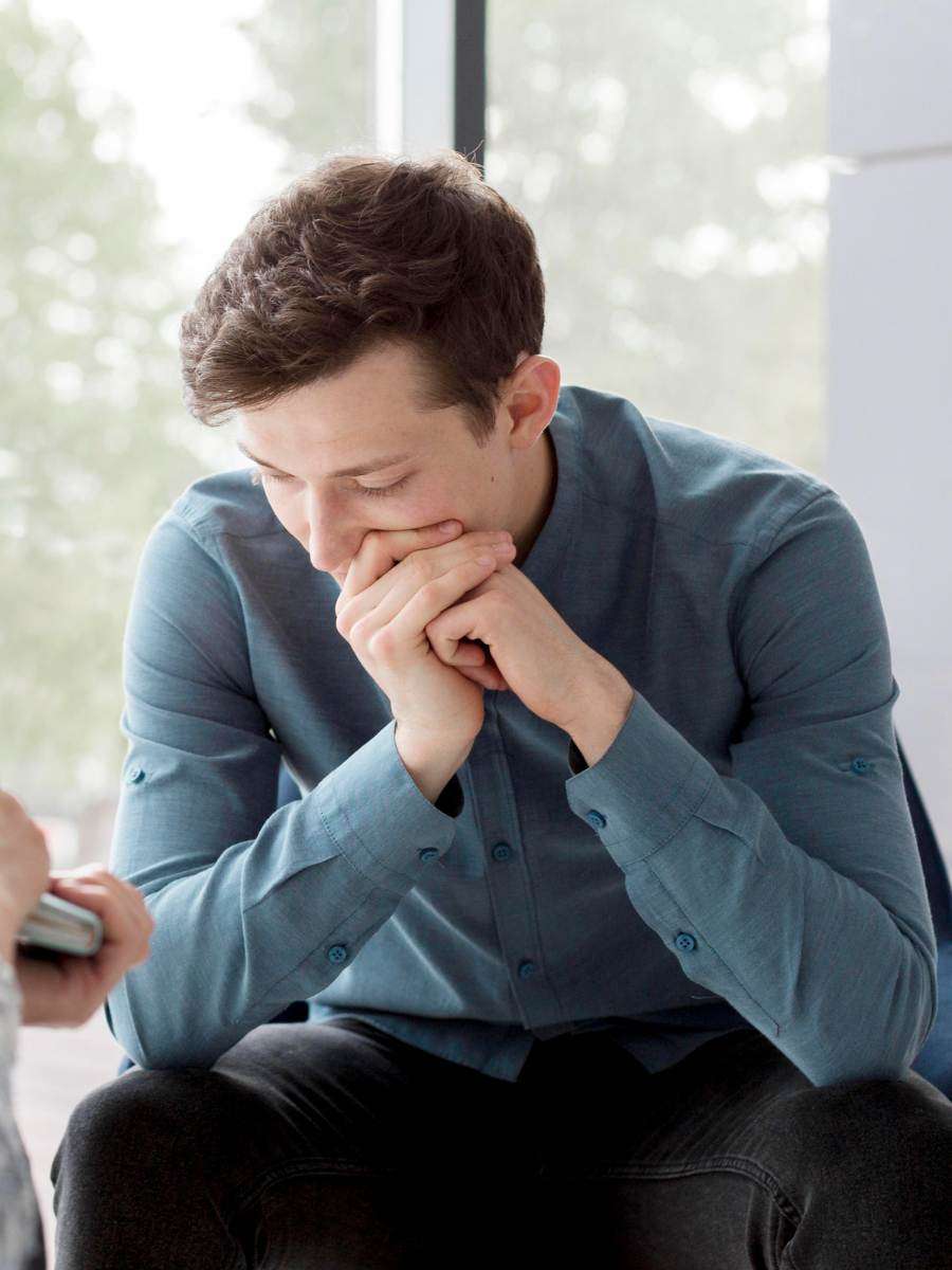 A man struggling with addiction and considering drug rehab for men.