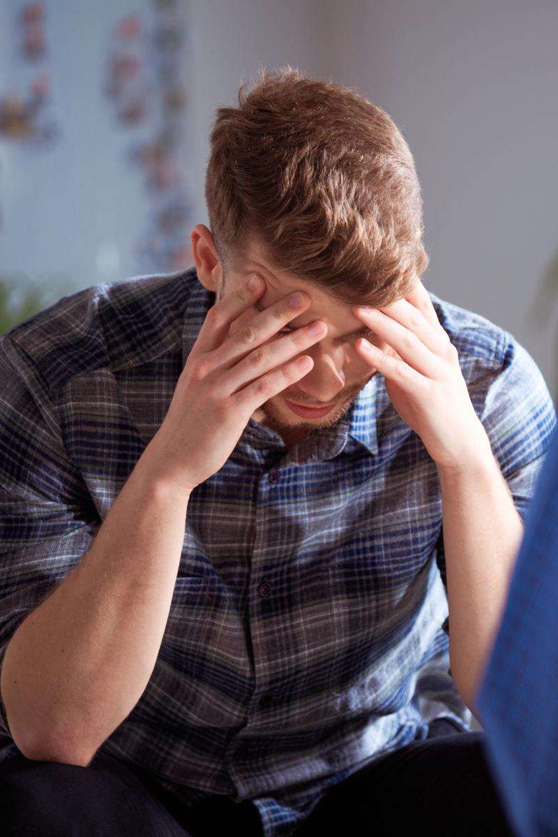 A man struggling with signs of drug withdrawal.